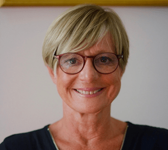 A headshot of a woman wearing glasses