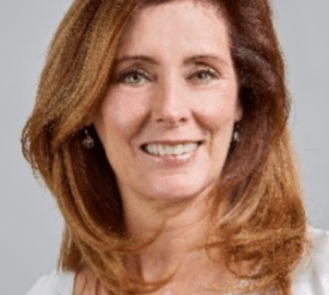 A headshot of a woman with brown hair